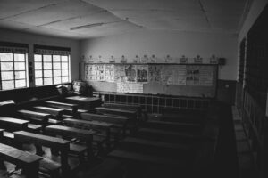 image of an empty classroom and rows of desks