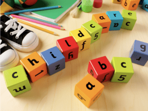 "childcare" and "ABCs" are written on colorful blocks; each block is different color and a pair of child's shoes peeks out from the corner