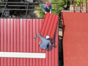 Two men working on a roofing job in an unsafe way.