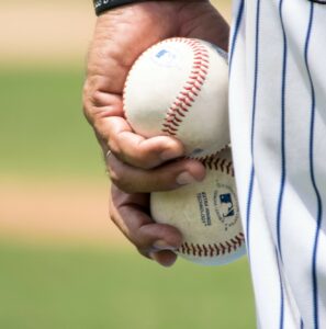 Player holding two baseballs.