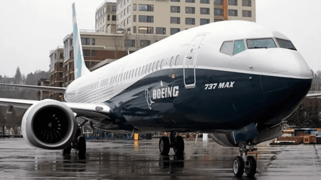 Boeing jet on a rain-soaked landing strip.