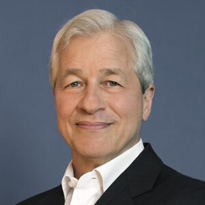 JPMorgan Chase CEO Jamie Dimon, white man smiling with white hair and wearing white shirt with black jacket.