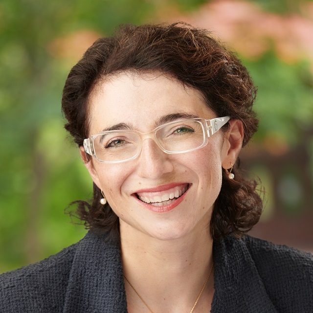 Image of white woman with short brown hair smiling.